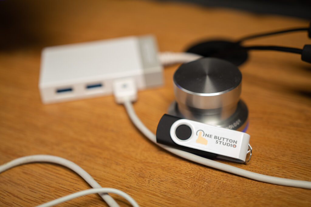 Closeup image of the One Button Studio button and USB drive