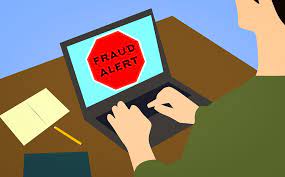 the words fraud alert on a laptop screen