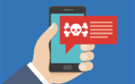 hand holding a phone with a crossbones image indicating smishing