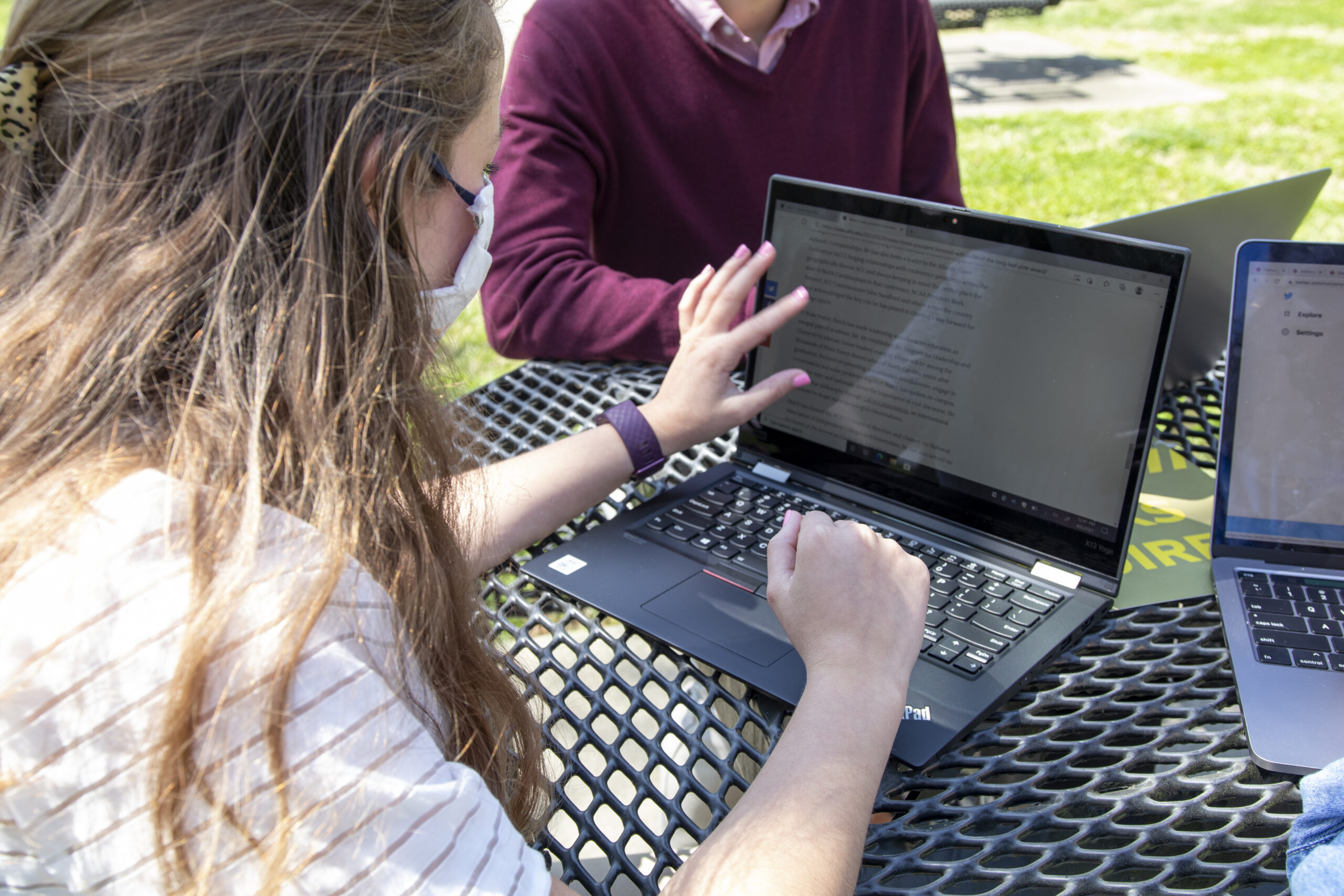 students using laptop outside